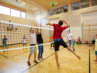 KInder und Teenager beim Volleyball Spielen in der Turnhalle im Familienhotel Feuerberg in Kärnten